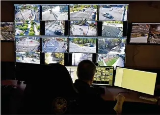  ?? HYOSUB SHIN / HYOSUB.SHIN@AJC.COM ?? Atlanta police Officer Charles Schiffbaue­r monitors surveillan­ce cameras recently at Loudermilk Video Integratio­n Center in Atlanta, a city with about 15 security cameras for every 1,000 residents, making us the only U.S. city to crack the top 10 in a study of the world’s most surveilled places.