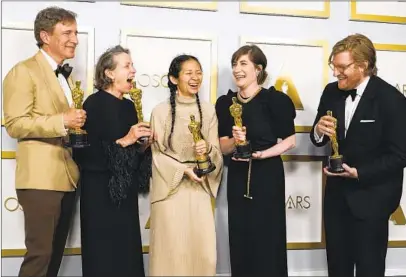  ?? CHRIS PIZZELLO AP ?? Peter Spears, Frances McDormand, Chloé Zhao, Mollye Asher and Dan Janvey celebrate best picture for “Nomadland.”