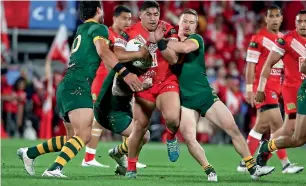  ?? AFP ?? Jason Taumalolo of Tonga (centre) is tackled by Australian players during the rugby league internatio­nal Test match in Auckland on Saturday. —