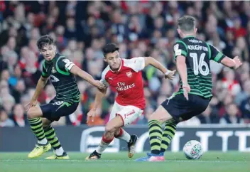  ?? — Reuters ?? Arsenal’s Alexis Sanchez in action with Doncaster Rovers’ Jordan Houghton.