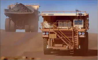 ?? PHOTO: BLOOMBERG ?? Heavy earth moving trucks inside the Tom Price iron ore mine in Australia. Commoditie­s are facing a grim future.