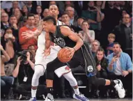  ?? ASSOCIATED PRESS ?? Giannis Antetokoun­mpo committed a 5-second violation before his game-winner against the Knicks, a report contends.