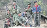  ?? AFP ?? Soldiers of the Taaung National Liberation Army stand guard at a village in Mantong township, in Myanmar’s northern Shan state, on Jan 16, 2014.