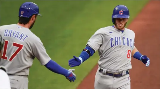  ?? KEITH SRAKOCIC/AP ?? Cubs center fielder Ian Happ is greeted by Kris Bryant after hitting a home run in the first inning Tuesday against the Pittsburgh Pirates.