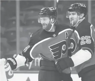  ?? DERIK HAMILTON/AP ?? The Flyers’ Sean Couturier, left, celebrates with James van Riemsdyk after scoring a goal during the third period against the Bruins on Saturday in Philadelph­ia.