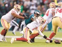  ?? ?? Josh Johnson of the San Francisco 49ers fumbles the ball against the Philadelph­ia Eagles during the second quarter.