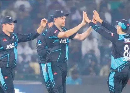  ?? PHOTO / AP ?? New Zealand's Jacob Duffy, centre, celebrates with teammates after taking the catch of Pakistan's Usman Khan during the fourth T20 internatio­nal cricket match between Pakistan and New Zealand yesterday.