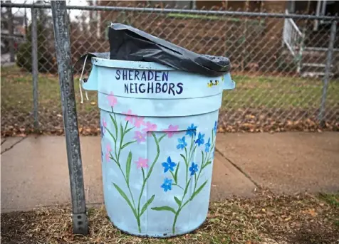  ??  ?? Flowers bloom on a Sheraden Neighbors trash can meant to encourage residents to not litter.