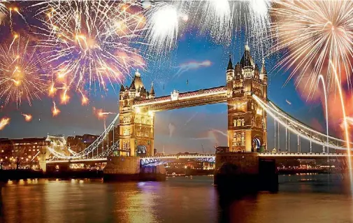  ??  ?? London’s Tower Bridge is illuminate­d as fireworks explode around it.