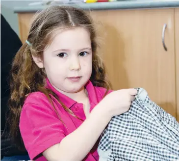  ??  ?? Left: Ava Mullen sorts some items to put into her bag.