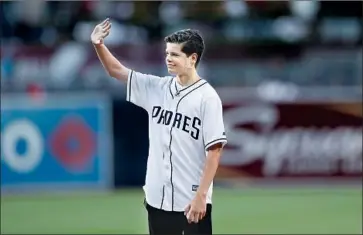  ?? Gregory Bull Associated Press ?? KEANE WEBRE-HAYES waves before throwing the ceremonial first pitch at a game between the host San Diego Padres and the San Francisco Giants.