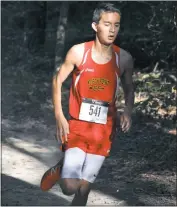  ?? STAFF PHOTO BY MICHAEL REID ?? North Point freshman Josh Doughty runs through the woods during Wednesday’s meet at Leonardtow­n that also included La Plata and Northern. Doughty finished fourth.