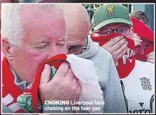  ?? ?? CHOKING Liverpool fans choking on the tear gas