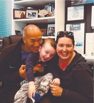  ??  ?? STILL SMILING: Sydney neurosurge­on Dr Charlie Teo with Mareeba boy Nate Moule and his mum, Katie Moule.