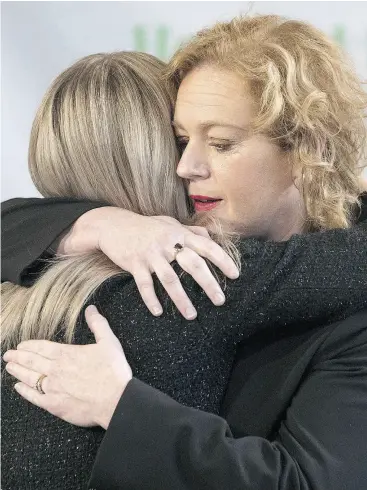  ?? CHRIS YOUNG / THE CANADIAN PRESS ?? Social Services Minister Lisa MacLeod, right, hugs her parliament­ary assistant Amy Fee, a mother of two children with autism on Wednesday.