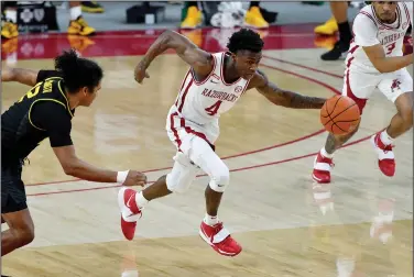  ?? Associated Press ?? Fast break: Arkansas guard Davonte Davis (4) against Missouri during the second half of an NCAA college basketball game Saturday in Fayettevil­le. The Razorbacks play at Tennessee tonight.