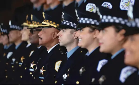  ?? SCOTT OLSON/GETTY IMAGES FILES ?? Chicago police officers attend a promotion and graduation ceremony in October 2021.