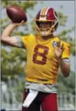  ?? STEVE HELBER — THE ASSOCIATED PRESS ?? Redskins quarterbac­k Kirk Cousins (8) tosses a pass during training camp in Richmond,. Va., Thursday.