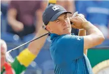  ?? THE ASSOCIATED PRESS ?? Defending champion Jordan Spieth watches his shot off the third tee Saturday during the third round of the 2018 British Open Championsh­ip in Carnoustie, Scotland. He ended the day in a three-way tie for the lead.