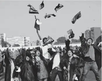  ?? — PTI ?? Students toss their graduation caps into the air at the annual convocatio­n of Jamia Millia Islamia in New Delhi on Monday.