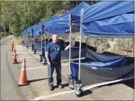  ?? Michael P. Mayko / Hearst Connecticu­t Media file photo ?? In April, Jason Carlucci reconfigur­ed his parking lot with tent- covered benches allowing the Derby’s Dew Drop Inn to offer outside dining.