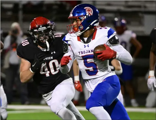  ?? CLIFF GRASSMICK — STAFF PHOTOGRAPH­ER ?? Fairview’s Brock Kolstad, left, tries to catch up to Fountain-fort Carson’s Mathias Price in their Class 5A playoff game Friday night at Recht Field in Boulder. Price scored six touchdowns in FFC’S victory, ending the Knights’ season at 9-2.