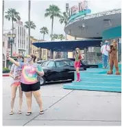  ?? DEWAYNE BEVIL/ORLANDO SENTINEL ?? Theme park visitors pose from an acceptable distance with Scooby-Doo characters at Universal Studios.