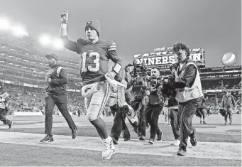  ?? CARY EDMONDSON/USA TODAY SPORTS ?? 49ers rookie quarterbac­k Brock Purdy celebrates as he runs off the field after defeating the Seahawks.