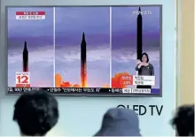  ?? LEE JIN-MAN/ AP PHOTO ?? People watch a TV screen showing a local news program reporting about North Korea’s missile launch at Seoul Train Station in Seoul, South Korea, on Wednesday.