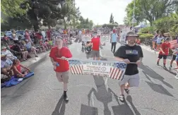  ?? PHOTOS BY MICHAEL CHOW/THE REPUBLIC ?? The Arcadia Fourth of July parade makes its way down E. Calle Tuberia in Phoenix on Wednesday. This is the 23rd year of the community event.