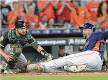  ?? Elizabeth Conley / Houston Chronicle ?? Brian McCann makes it home safely on Jake Marisnick’s seventh-inning double, beating the tag of Jonathan Lucroy.