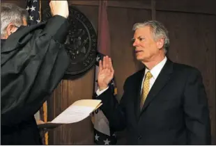  ?? The Sentinel-Record/Richard Rasmussen ?? TAKING THE OATH: Division 3 Circuit Judge Lynn Williams, left, swears in Pat McCabe as mayor Wednesday at the Garland County Court House. McCabe was one of four candidates vying for the mayoral appointmen­t from the Hot Springs Board of Directors.