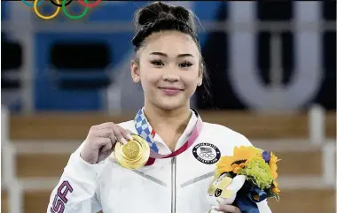  ?? GREGORY BULL AP ?? Gold medalist Sunisa Lee of the United States topped Brazil’s Rebeca Andrade to win the artistic gymnastics women's all-around on Thursday. ‘It doesn’t seem like real life,’ she said.