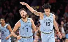  ?? AP Photo ?? ■ Memphis Grizzlies forward Brandon Clarke (15) reacts after he made a threepoint basket with forward Kyle Anderson (1) during the second half against the Washington Wizards on Sunday in Washington.