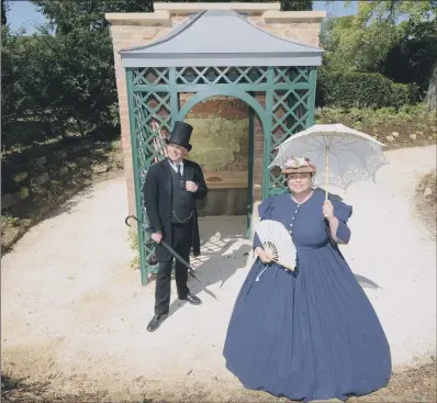  ??  ?? Victorian reenactors launch the newly refurbishe­d outdoor privy at Brodsworth Hall .