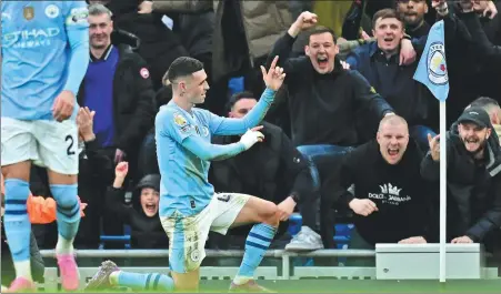  ?? AFP ?? Phil Foden celebrates in front of the Manchester City fans after scoring his second goal in the 3-1 derby defeat of Manchester United at the Etihad Stadium on Sunday.