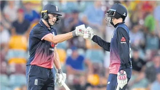  ??  ?? England’s Chris Woakes, left, and Joe Root celebrate winning the second one-day internatio­nal match at the Gabba in Brisbane.