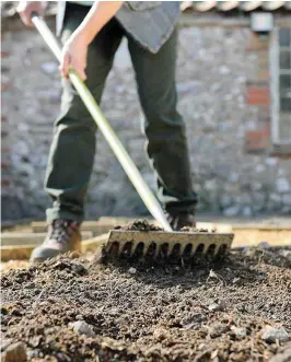  ??  ?? Use a rake to break up any large lumps of soil in your borders