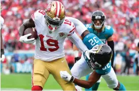  ?? Tribune News Service/getty Images ?? Deebo Samuel #19 of the San Francisco 49ers breaks a tackle by Tyson Campbell #32 of the Jacksonvil­le Jaguars during the second quarter at TIAA Bank Field on Sunday in Jacksonvil­le, Florida.