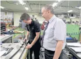  ??  ?? CLOSE EYE: FSG Tool and Die managing director Gareth Jenkins with a worker on the shop floor.