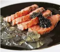  ??  ?? The salmon tataki with black sesame dressing and jalapeno jelly offered bursts of bouncy jelly, sweet sesame and perfectly cooked fish.