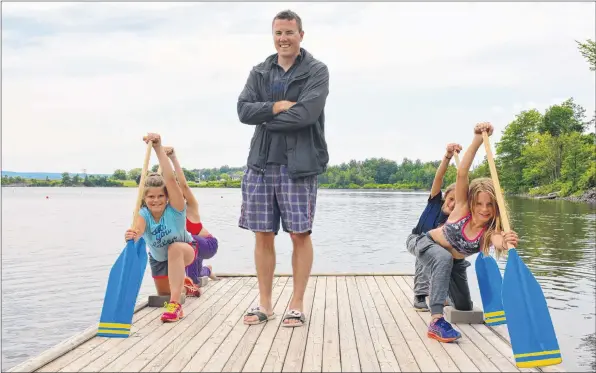  ?? COLIN CHISHOLM ?? Pisiquid Canoe Club head coach Christian Hall, flanked by club paddlers Kyanna Hope, 11, Sierra Kelly, 11, Maura Macumber, 10 and Ava Woodman, 9 on Lake Pisiquid, has a passion for teaching young athletes.