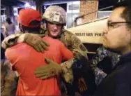  ?? THE ASSOCIATED PRESS ?? A protester embraces a member of the National Guard in Charlotte, N.C., on Thursday night.