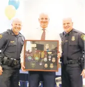  ?? COURTESY ?? Jason T. Bollhorst, center, will serve as the police chief in Albemarle, North Carolina, after more than 26 years with the Newport News Police Department.