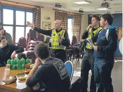  ?? Picture: George McLuskie. ?? Police officers speak to students helping in the search for Duncan Smith.