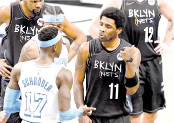  ?? - AFP photo ?? Dennis Schroder #17 of the Los Angeles Lakers and Kyrie Irving #11 of the Brooklyn Nets have words after Irving was called for a foul against Schroder in the third quarter at Barclays Center on Saturday.