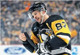  ?? CHARLES LECLAIRE ■ USA TODAY SPORTS ?? Pittsburgh Penguins centre Sidney Crosby prepares his stick before a face-off during Monday’s game against the Nashville Predators at PPG Paints Arena in Pittsburgh.