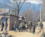  ?? PTI ?? CRPF jawans stand guard at Nigeen Pora during an encounter in Tral on Sunday. A police constable was killed in the operation.