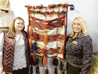  ?? Photos by Jack Sheedy/For Hearst Connecticu­t Media ?? Danielle Bilodeau and her mother, Pam Fiorillo, stand near a vintage Middle Eastern saddle blanket in their Winsted store, Peacocks and Lilacs Thrifty Boutique.