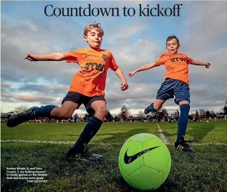  ??  ?? Armani Wright, 8, and Toby Cooper, 7, are looking forward to finally getting on the football field and scoring some goals.
TOM LEE/STUFF